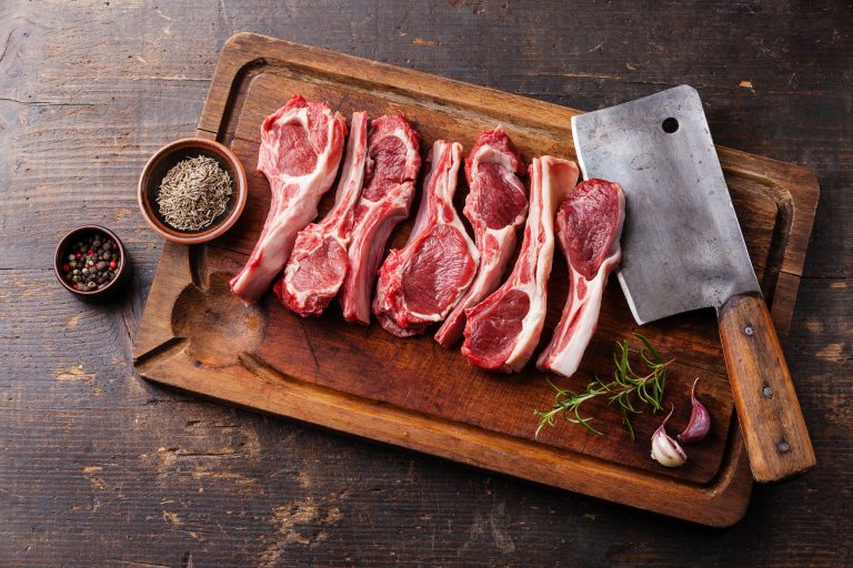 raw lamb ribs, meat cleaver, seasonings